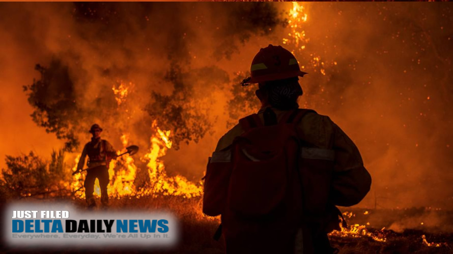 Crews work in scorching heat Wednesday to fight the wildfires that ignited in Northern California.